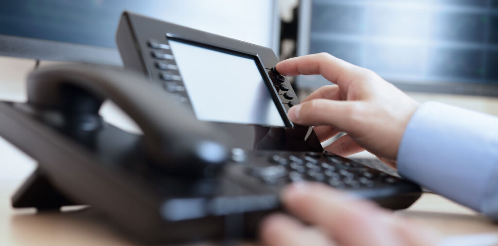 Hand on Telephone Keypad